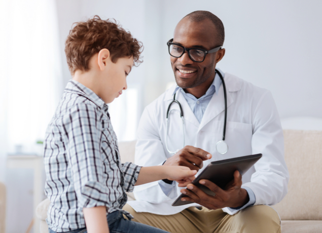 kid with doctor pointing at ipad